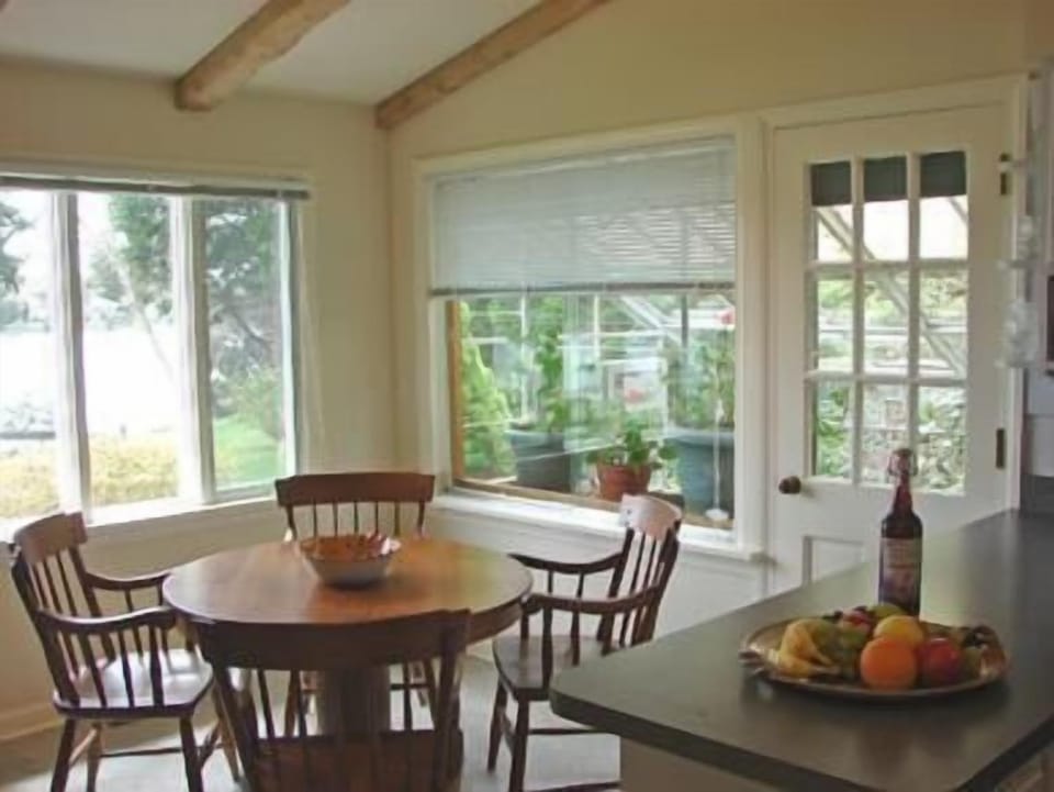 Second dining area in kitchen, with views, adjacent to flowering greenhouse