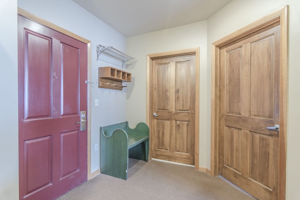 Entry - Offers a small bench, coat hooks, and shelves. Also accesses the bathroom and master bedroom.