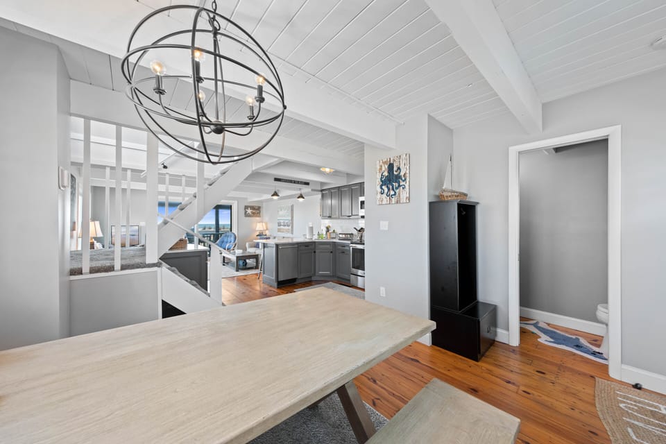 Views from dining table to powder room on the right and towards kitchen. 