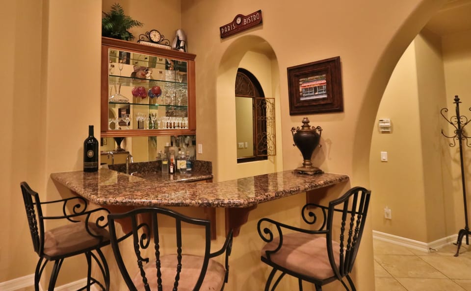 The great room features a sleek wet bar to stir up some drinks for friends