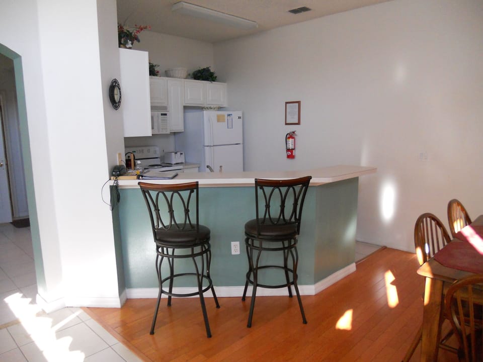 KITCHEN AREA WITH BAR CHAIRS 