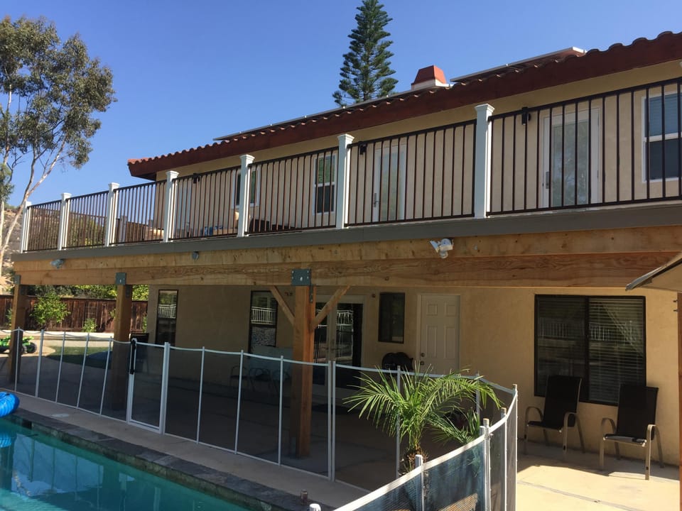 View of the 2nd story deck. View of pool fence which can be taken down.
