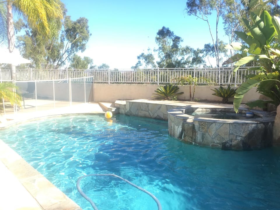 Swimming pool with shallow and deep end. Full removable fence around pool