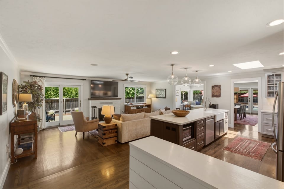 the "Great Room" with 70" TV, spacious sofa, and fully equipped kitchen.