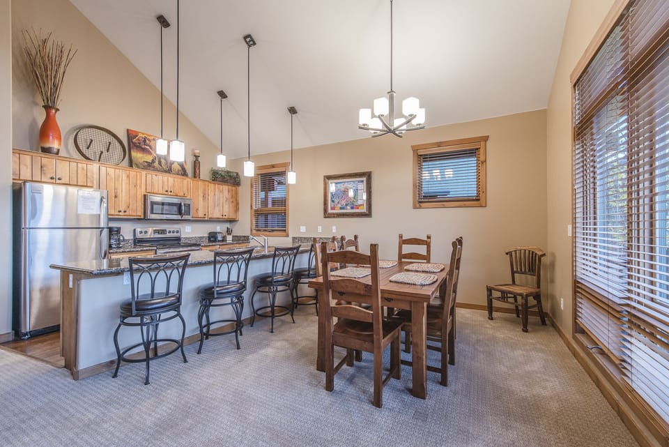 Dining Area - Wooden table with seating for six guests plus two additional chairs. Counter seating for five also available.