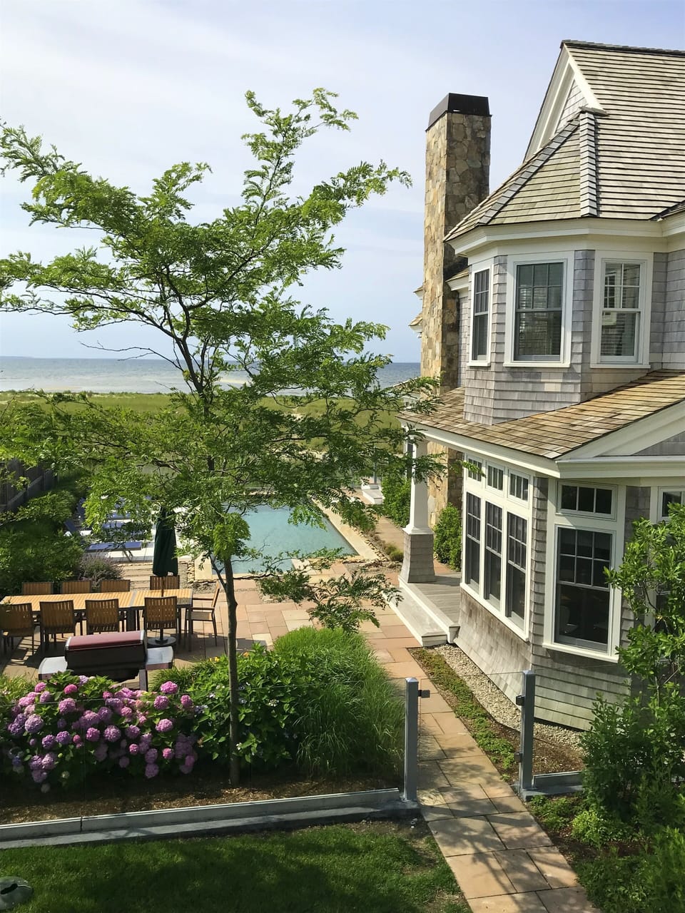 View to pool, main house, and Bay from Carriage house deck.