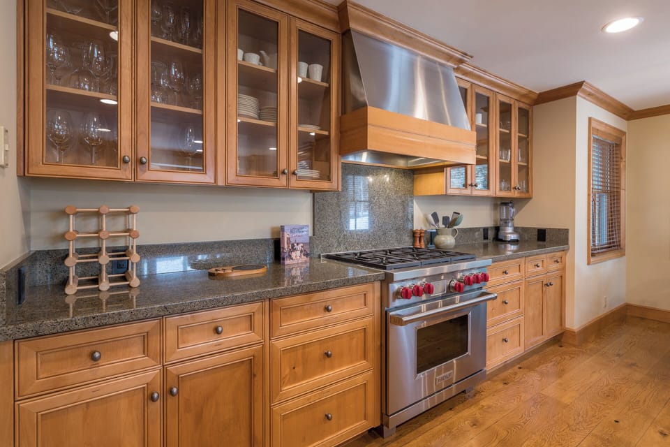Step into your gourmet kitchen featuring rich wood cabinetry, granite countertops, and professional-grade appliances perfect for creating memorable meals.