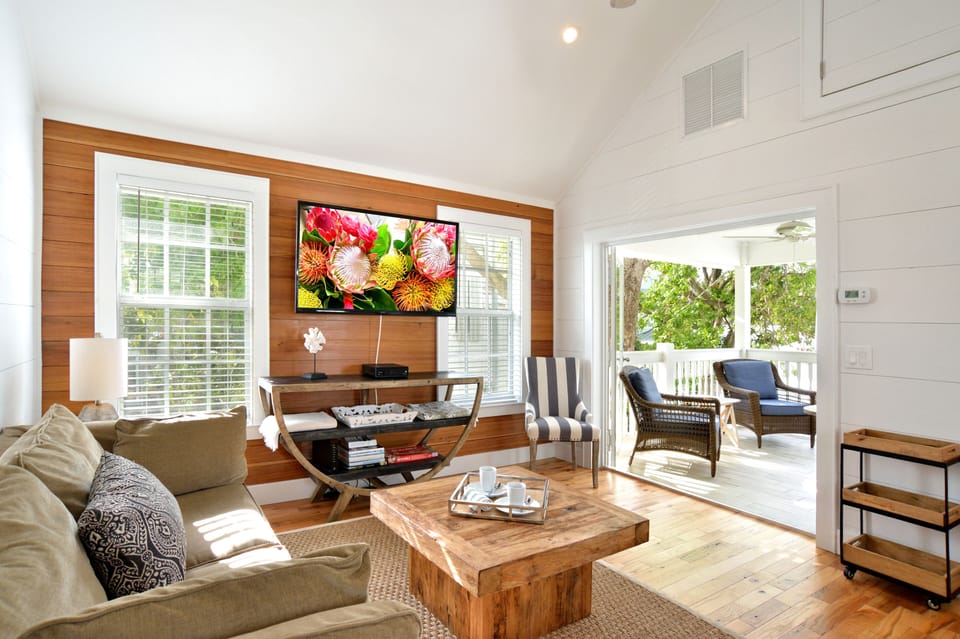 Beautiful living room w/ vaulted ceilings & large TV.