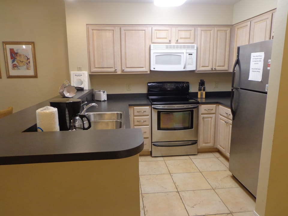 Full kitchen with coffee maker.