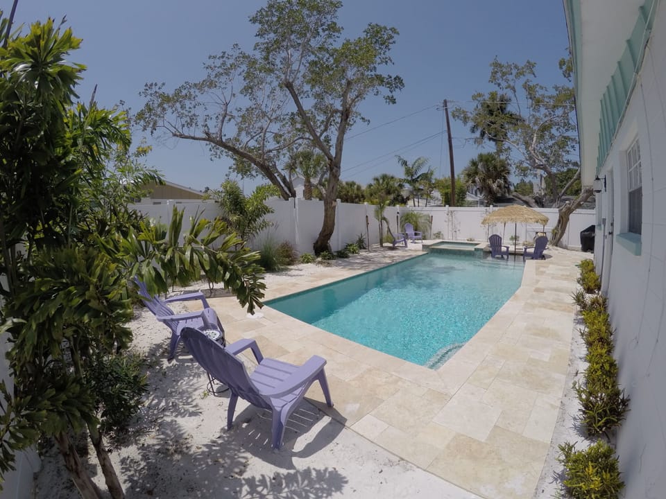 heated pool, sun shelf, built in hot tub, out door television grill