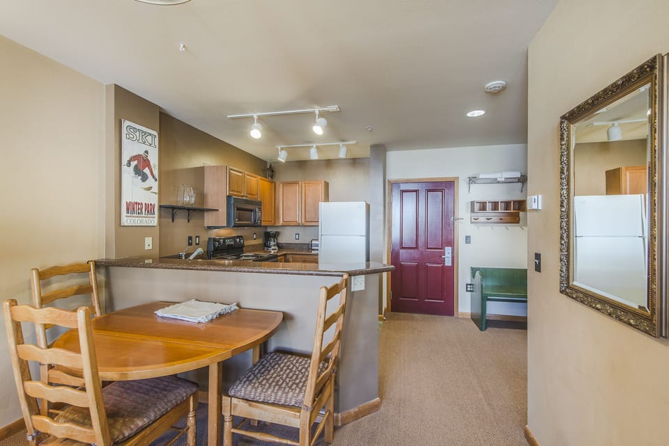 Dining Area - Round, drop-leaf table with seating for four guests.