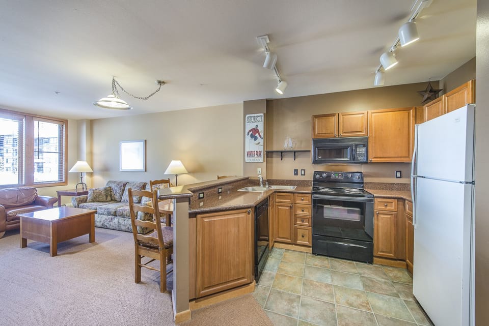 Kitchen - Nicely upgraded space with granite counters, double sinks, and full size appliances.