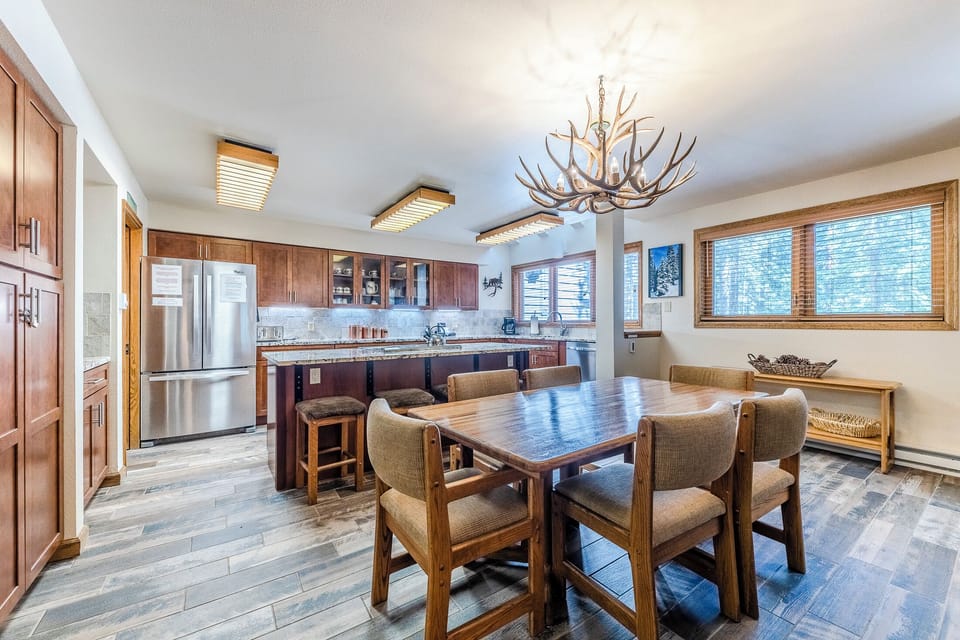Dining Area - Located between the kitchen and the living area with an antler chandelier above the table which seats six guests.