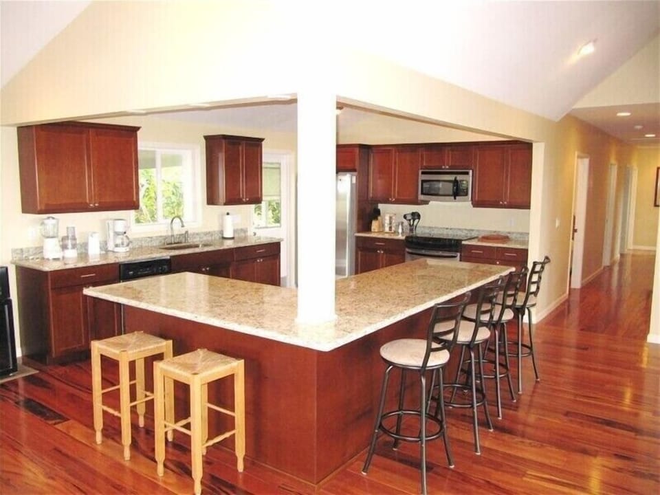 Large Kitchen with Granite Countertops, Rotating Stools &amp; Tiger Wood Flooring