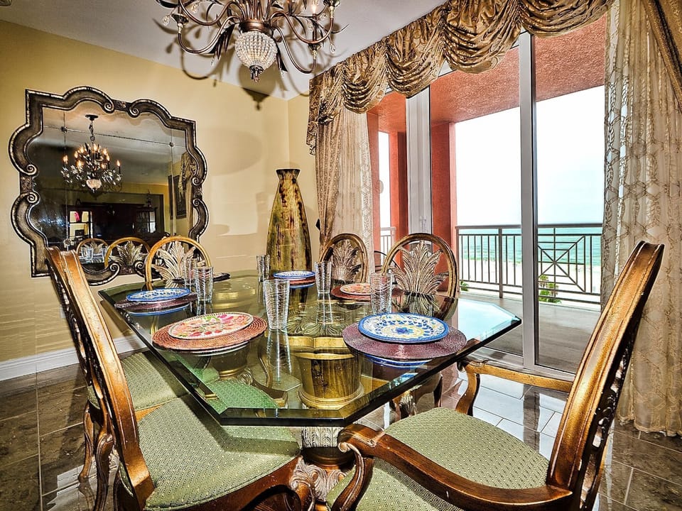 Dining area has seating for 6 guests and access to the balcony.