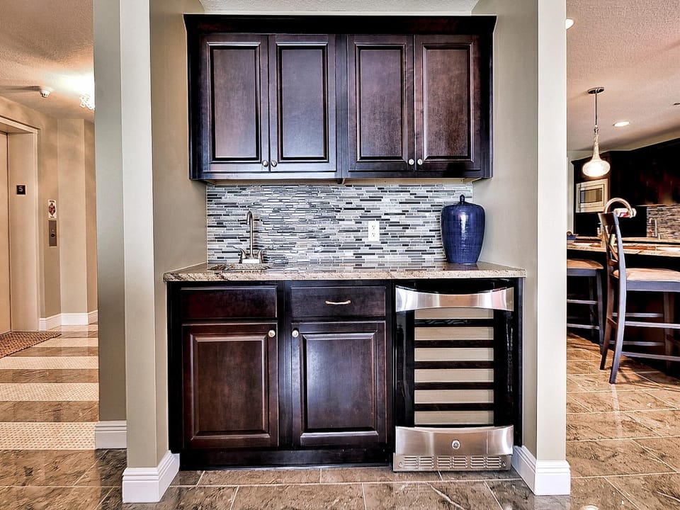 Wet bar has sink and built in wine cooler.