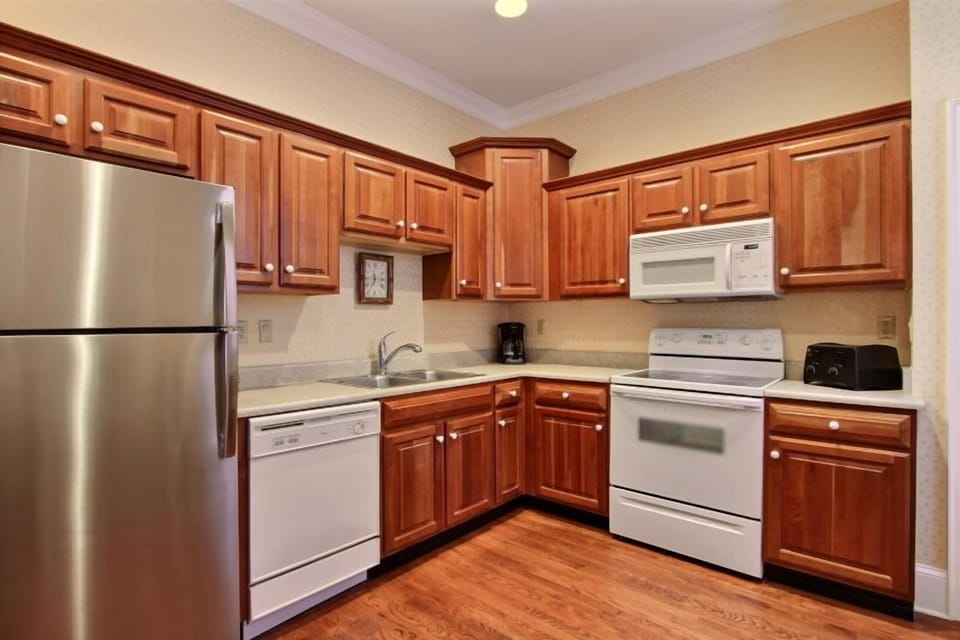 A large kitchen with utensils and cookware for you to prepare in house meals. 