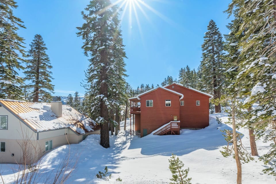 A shared back garden offers open space to relax, play, and take in the mountain setting—quiet, green in summer, and snow-covered in winter.