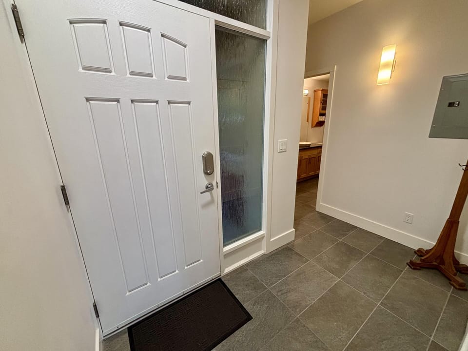 Welcoming entryway with modern lighting and spacious tile flooring