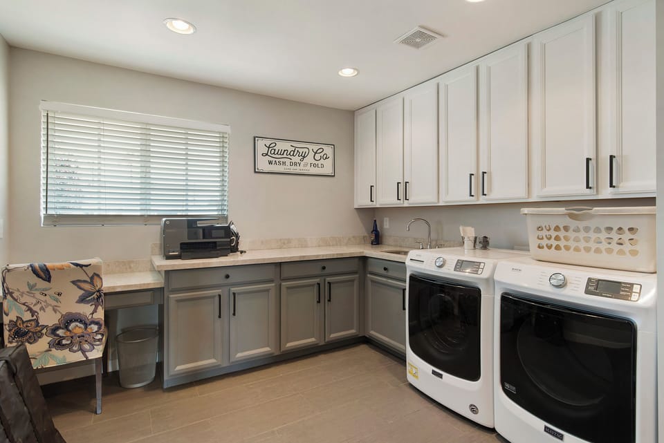 Spacious utility room with desk, printer, and optional fourth bedroom setup.
