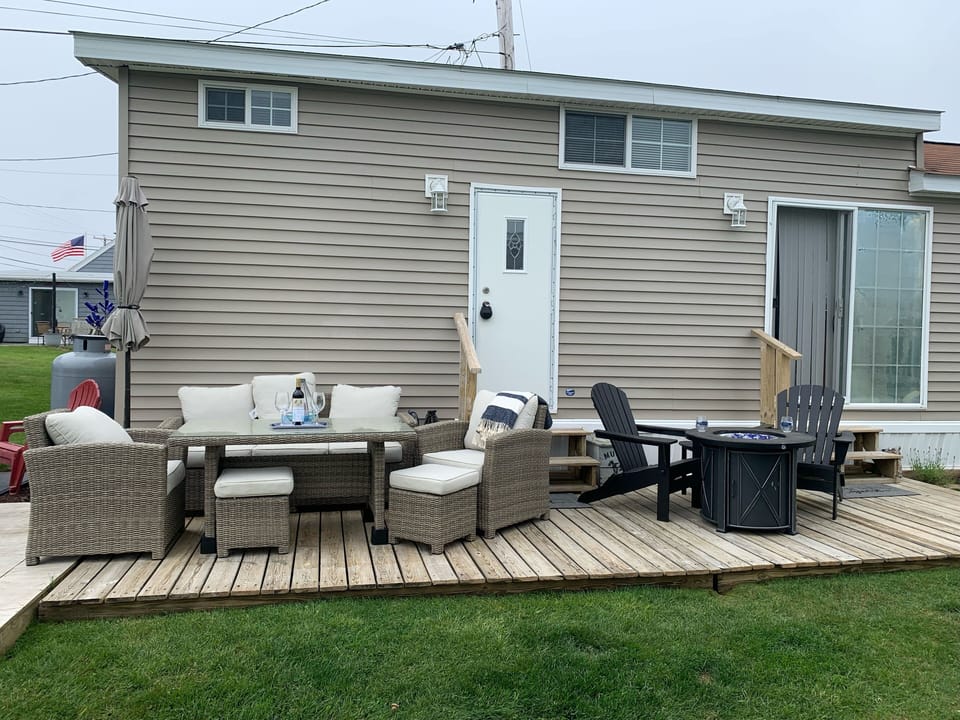 Deck with gas fire pit, dining set, and gas grill