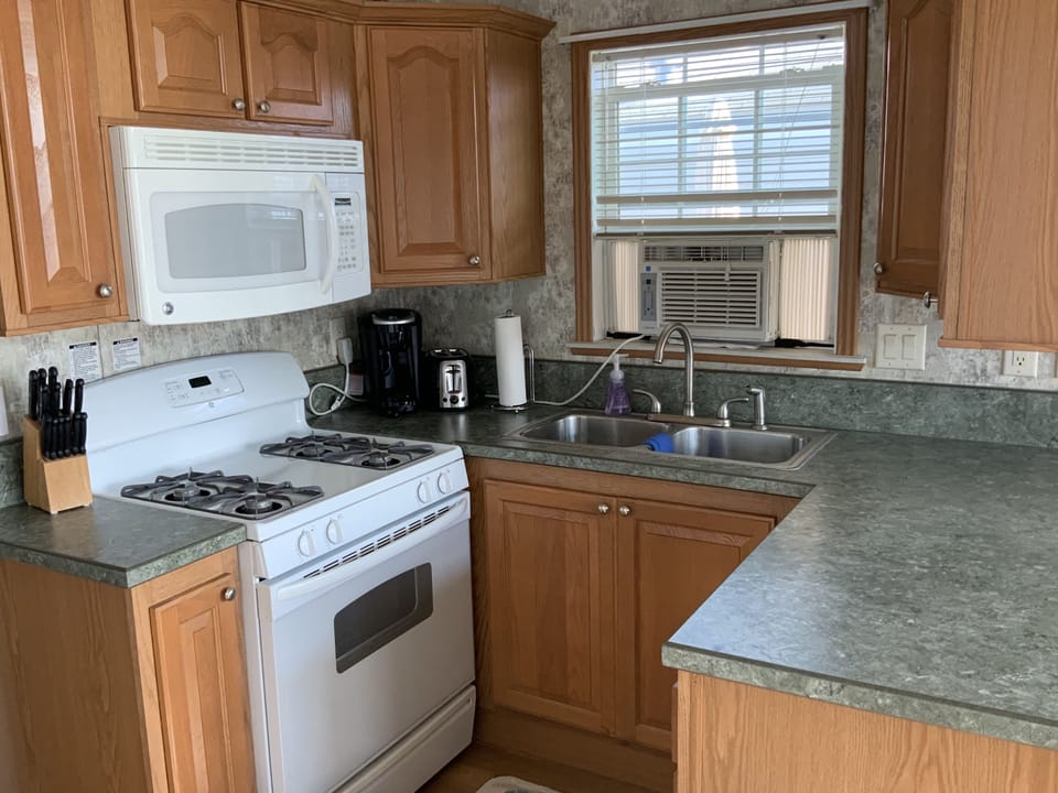 Fully equipped kitchen with propane stove, microwave, and Keurig