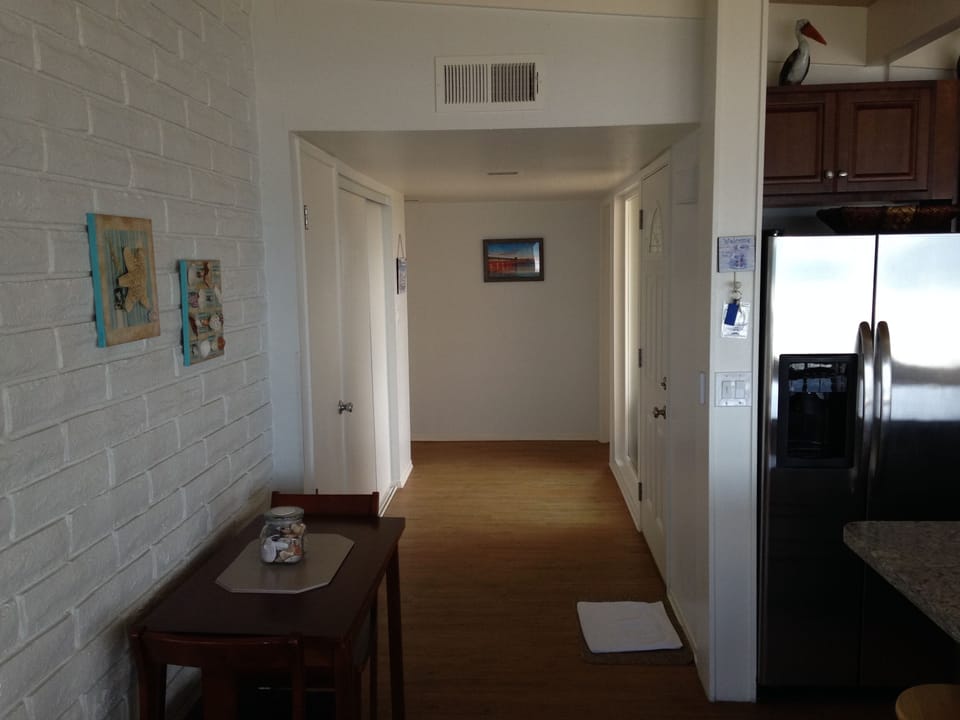 Hallway leading to two large bedrooms and bathroom. 