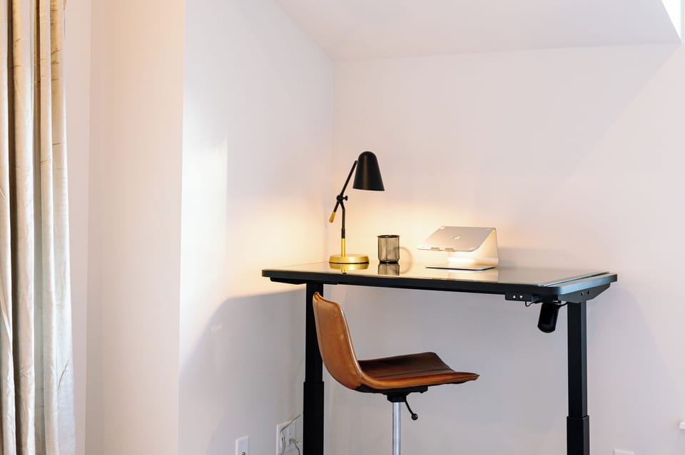 Electric Adjustable Height Sit/Stand Desk and comfortable swivel Leather Chair