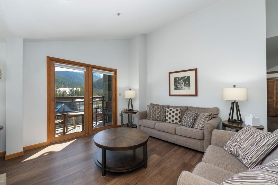 Living room - Bright living room w/view of The Village and the Continental Divide. 3 seater sofa can convert to a sleeper sofa w/linens left in bedroom closet