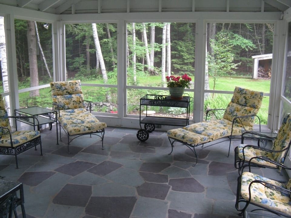 Screen porch with views to lake, garden and meadow.  Dining area to left of phot