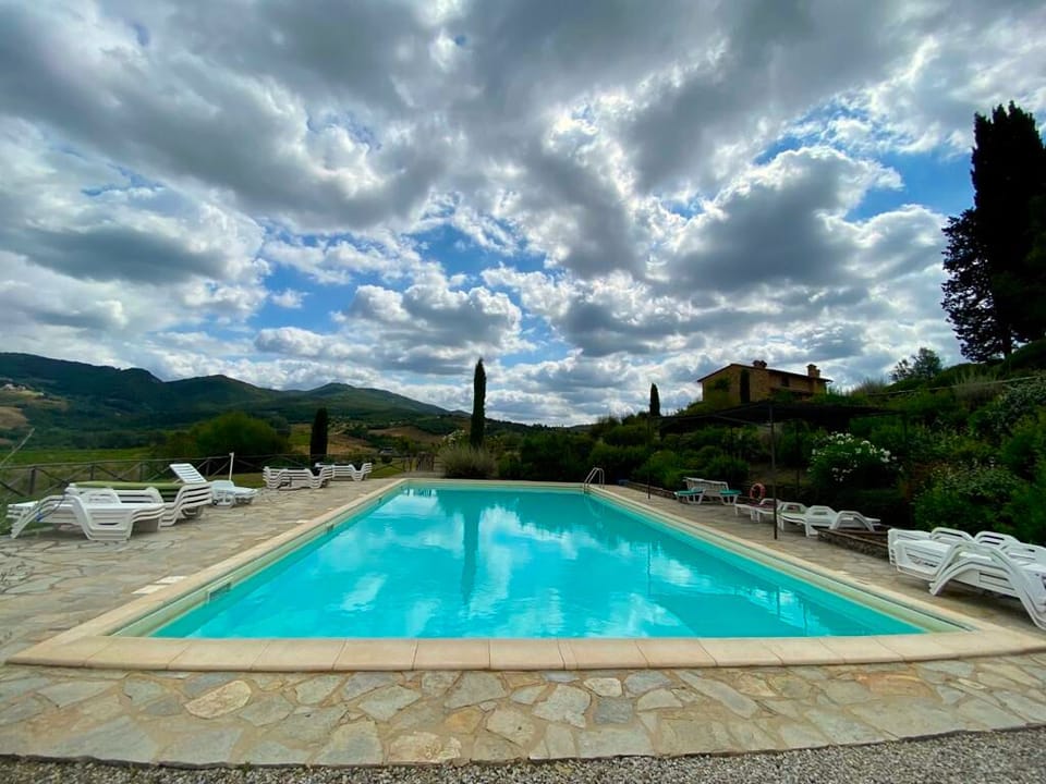 Collinella's large pool and paved gazebo with views of the landscape