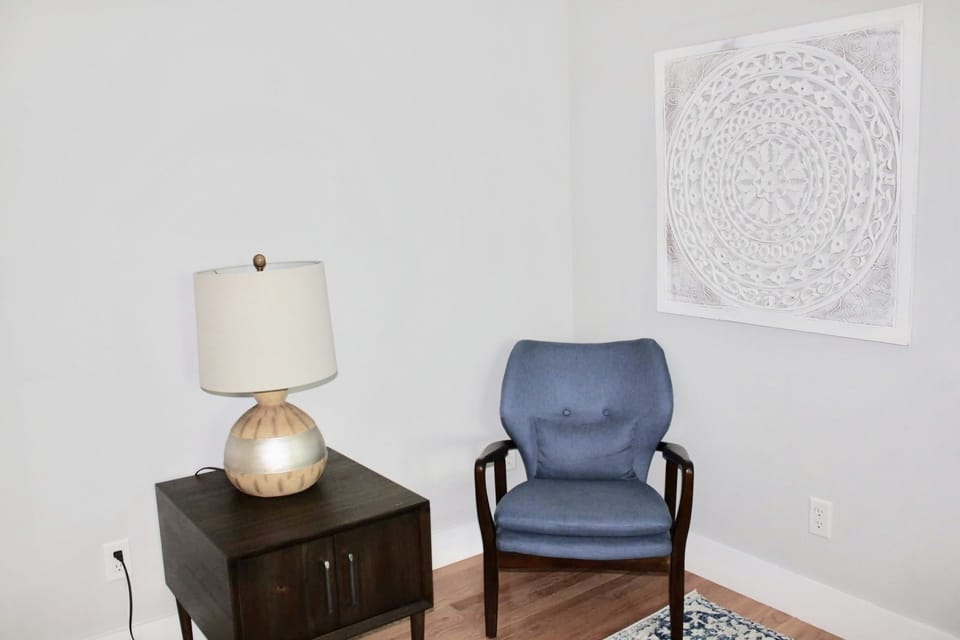 A cozy corner in the biggest  bedroom provides a place to sit and relax 