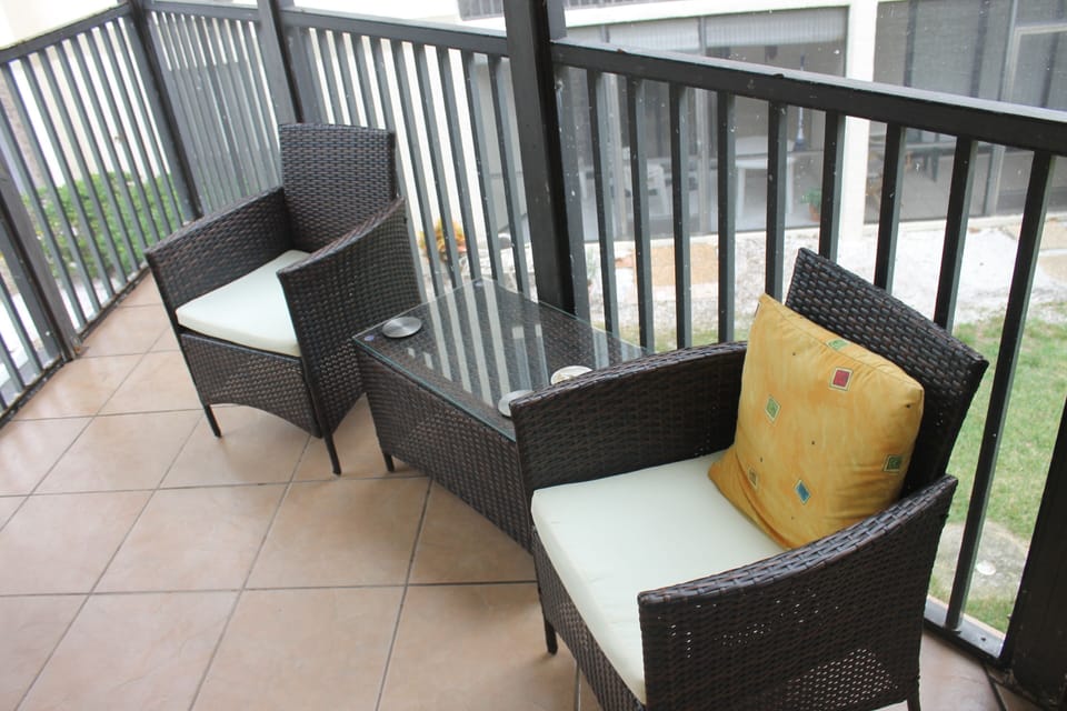Enjoy morning coffee or evening cocktails on screened in porch off the living rm