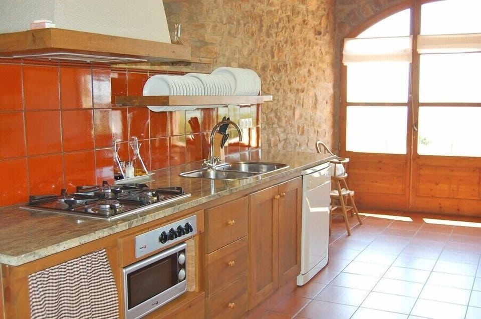 The kitchen is modern and is fully equipped