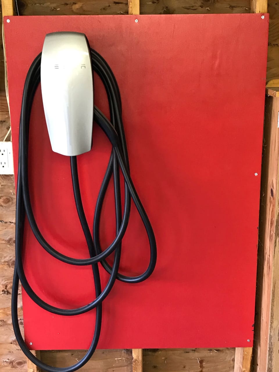 Tesla wall connector charger in garage. 