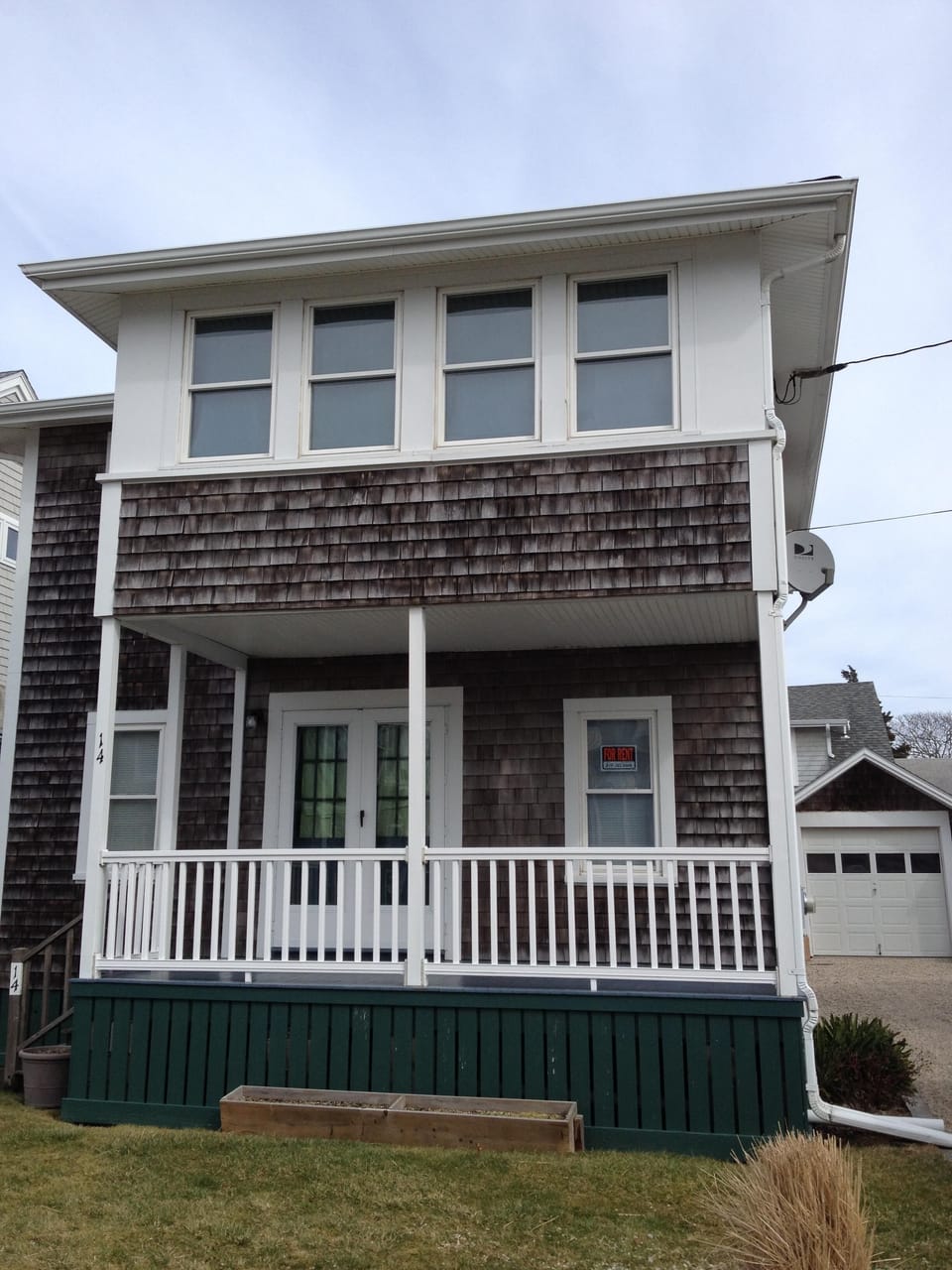 Front of house with enclosed upper sun-room
