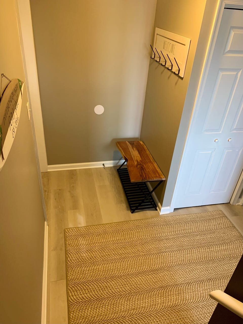 Stack washer and dryer in newly renovated foyer.