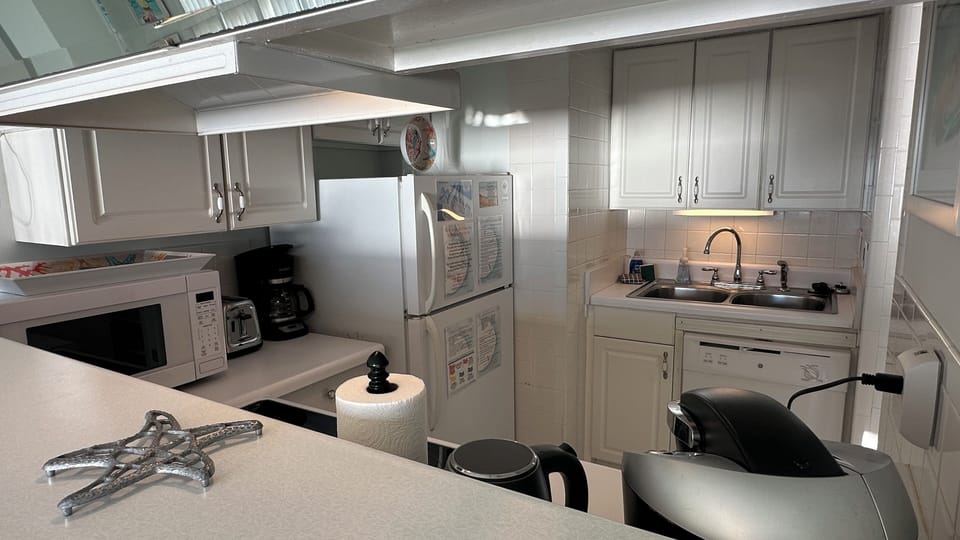 The kitchen is equipped with coffee maker, frig with an icemaker, & dishwasher.