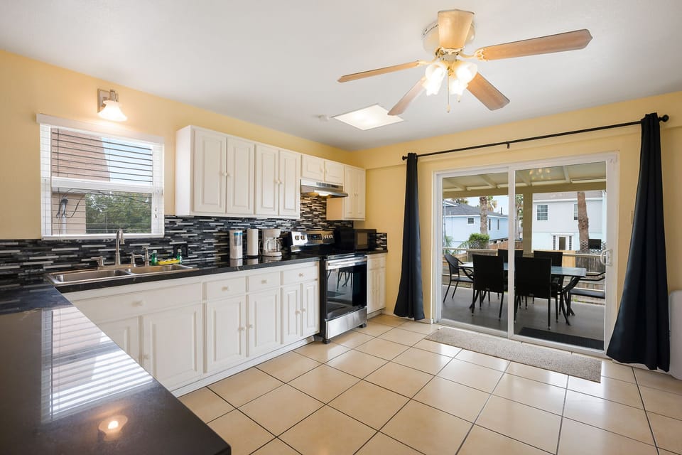 Large kitchen with deck access (leads down to the pool area).