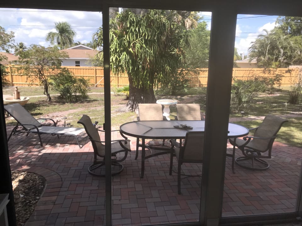 Parkview room opens to large private yard, set up for BBQ, w/table & grill.  