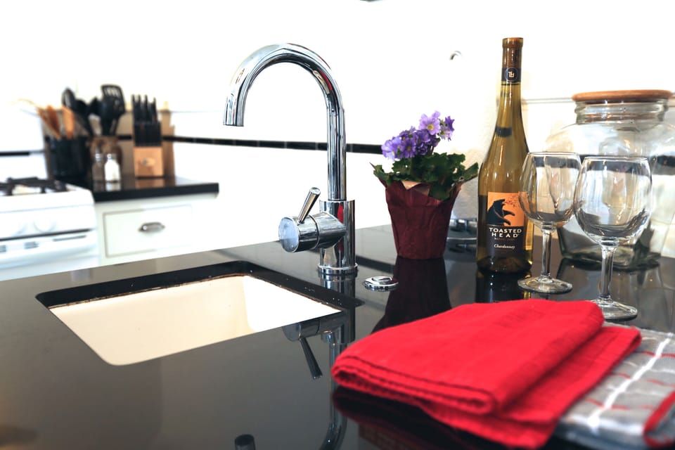 Small island sink for prep work includes a garbage disposal.
