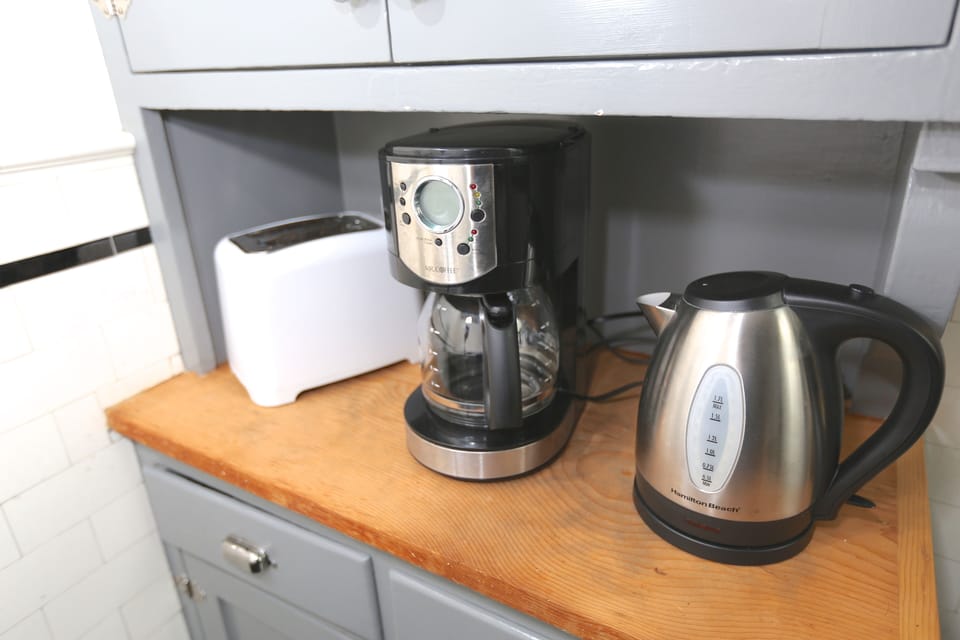 Toaster, coffee maker,  electric teapot & all the dishes you need.