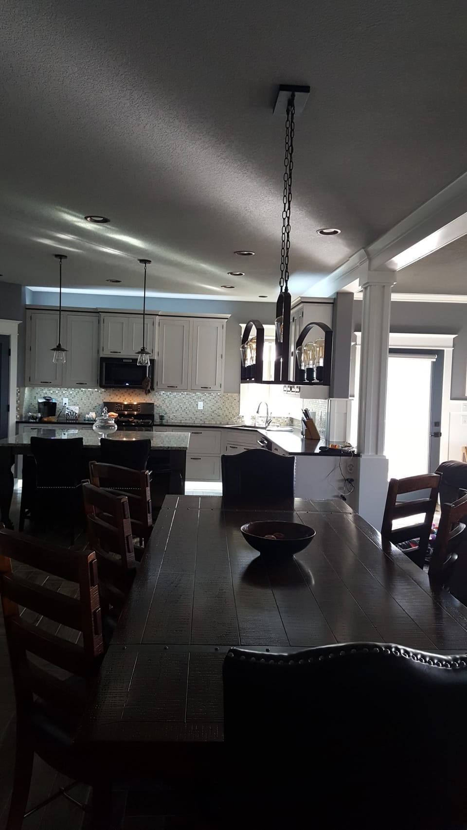 Open living area with an oversized dining table to fit the whole family.