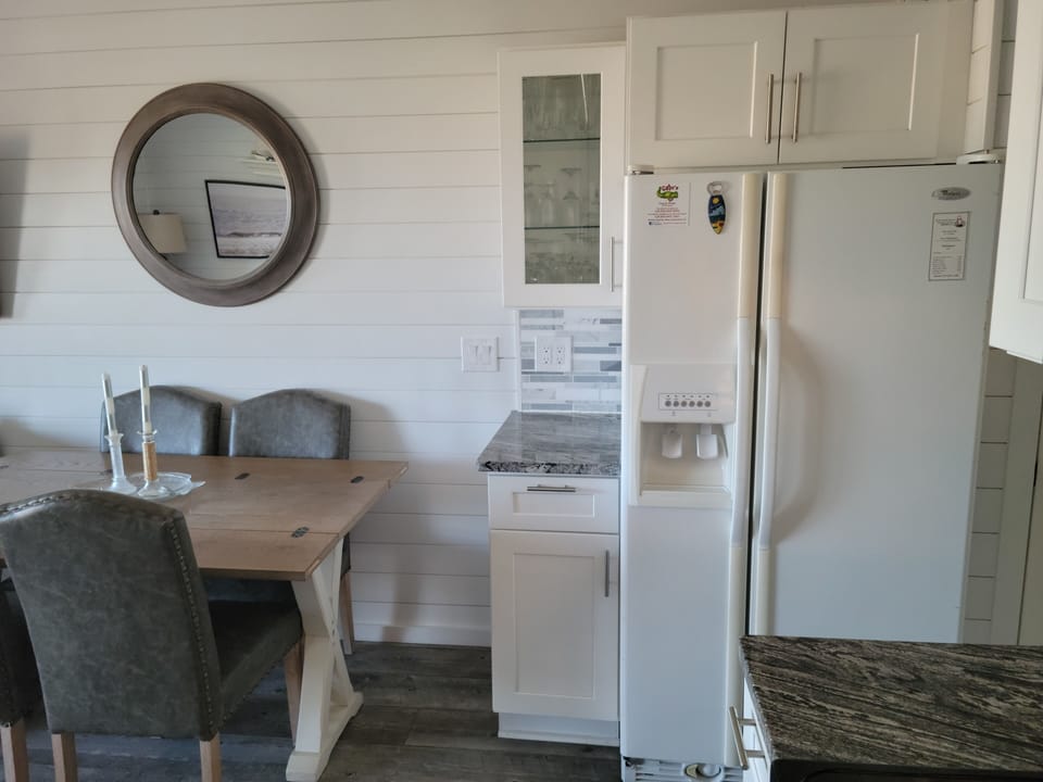 Full size refrigerator with ice maker and water dispenser in door. 