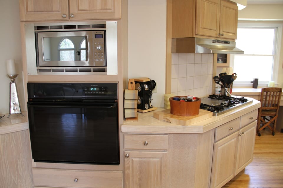 The kitchen is fully stocked with appliances, tableware, and utensils 