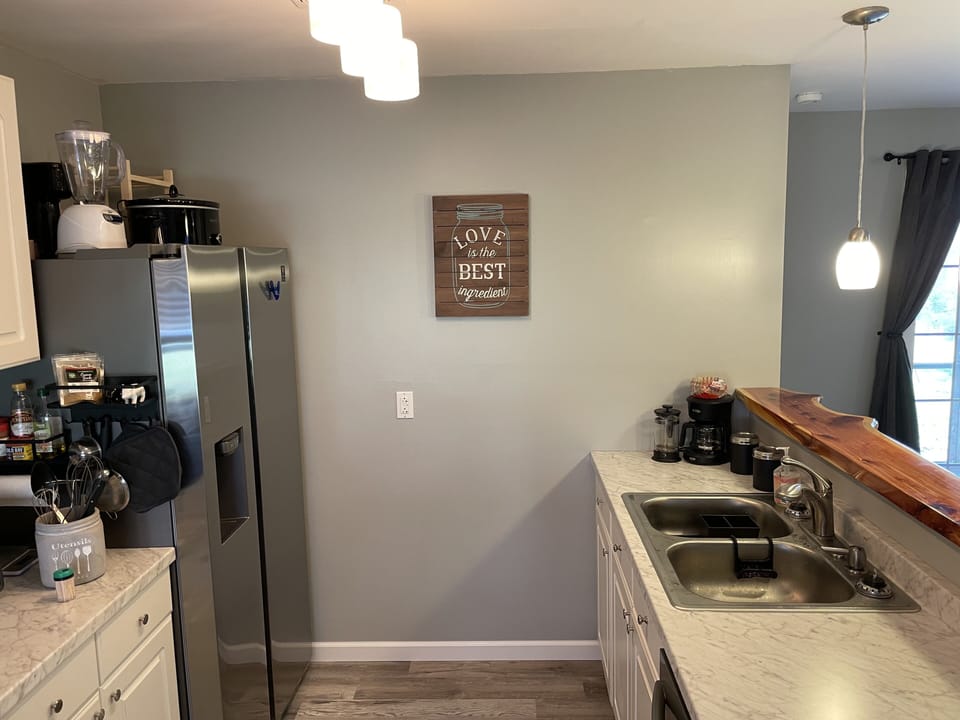 Our beautiful kitchen with live edge cedar bar top and brand new appliances