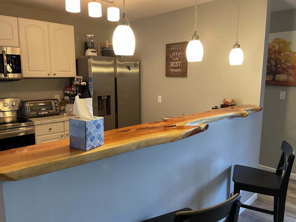 Our beautiful kitchen with live edge cedar bar top and brand new appliances