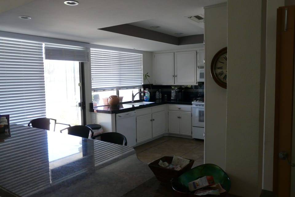 Open living design. Bar opens to kitchen and onto patio.