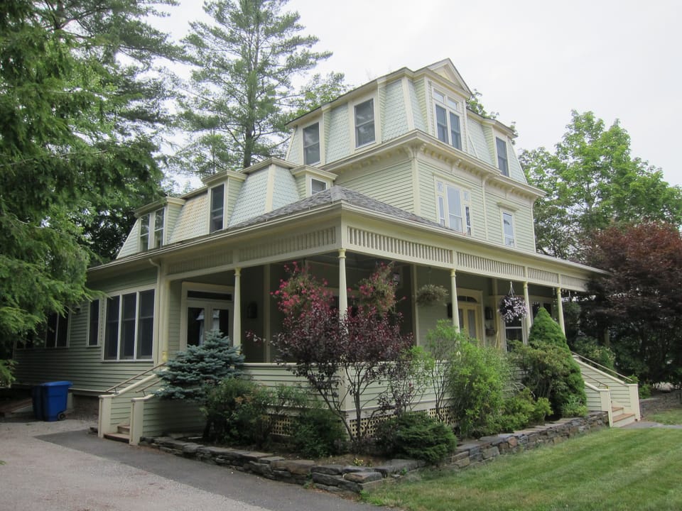 View of wraparound porch from the driveway (parking area fits up to 5 cars)
