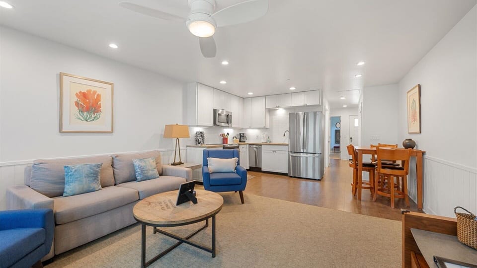 The living room has an open floor plan and there is a dining area for 4.
